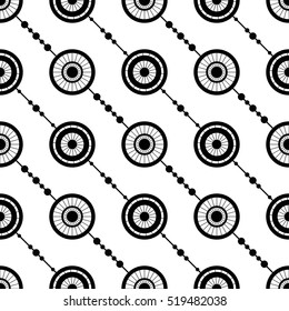 Tiled seamless geometric pattern of circles divided into sections. Garlands. Beads. Abstract black and white background. Vector illustration.