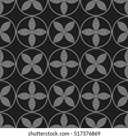 Tiled seamless geometric pattern of dotted circle with flowers in the center. Floral motif. Beads.  Abstract black and white mosaic background. Vector illustration.