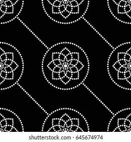 Tiled seamless geometric pattern of dotted flowers, circles and garlands. Beads. Abstract black and white mosaic background. Vector Illustration.