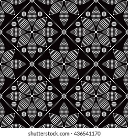 Tiled seamless geometric trellis pattern of dotted petals and flowers. Tracery Floral motif. Beads. Abstract black and white mosaic background. Vector illustration.