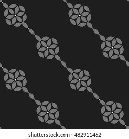 Tiled seamless pattern of hexagons and chains made of dotted petals. Garlands. Abstract black and white mosaic background. Vector illustration.