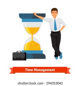 Time management concept. Businessman with briefcase in a tie leans on big half full sand hourglass. Flat style isolated vector illustration.