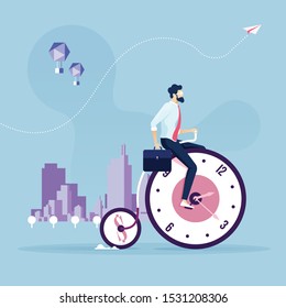 Time management concept-Businessman bike on bicycle wheel clocks