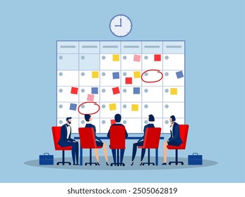 Time management, planning for team concept.Company business team working together planning and scheduling their operations agenda on a big spring desk calendar.