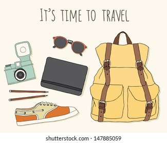 It's time to travel. Traveler's stuff: backpack, glasses, notebook and pencils, camera, shoes.