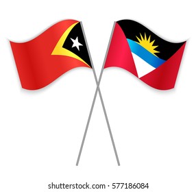 Timorese and Antiguan crossed flags. East Timor combined with Antigua and Barbuda isolated on white. Language learning, international business or travel concept.