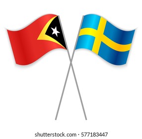 Timorese and Swedish crossed flags. East Timor combined with Sweden isolated on white. Language learning, international business or travel concept.