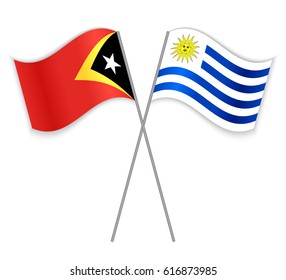 Timorese and Uruguayan crossed flags. East Timor combined with Uruguay isolated on white. Language learning, international business or travel concept.