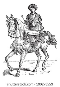 Timpani, or kettledrums, vintage engraved illustration. Man with kettledrum on horse. Dictionary of words and things - Larive and Fleury - 1895.