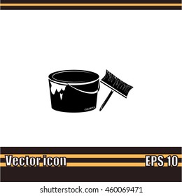 A tin of paint and brush