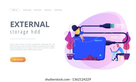 Tiny business people at laptops using portable external hard drive. External hard drive, data storage device, external storage hdd concept. Website vibrant violet landing web page template.