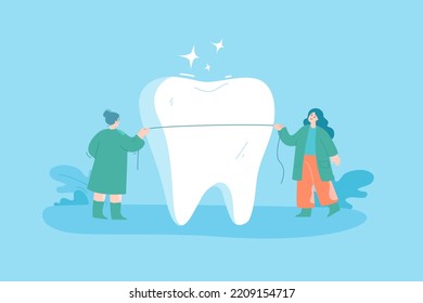 Tiny dentists with dental floss cleaning huge tooth. Cartoon women flossing teeth of patient flat vector illustration. Oral hygiene, dentistry, health concept for banner or landing web page