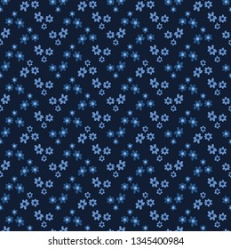 Tiny flower blossom sprinkles seamless pattern. Pretty fashion print vector illustration. Repeatable floral wallpaper tile . Hand drawn modern alloverprint home decor background. Denim indigo blue.