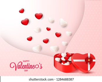 Tiny heart shape popping out from gift box on dotted pink background for Valentine's Day poster or greeting card design.