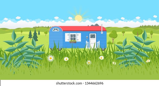 tiny house on wheels construction trailer with green landscape as background flat design icon