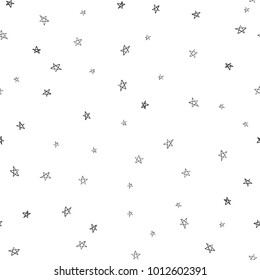 Tiny little stars seamless pattern. Black doodle star illustration on white background in hand drawn hipster style.