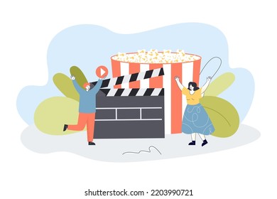 Tiny people near huge popcorn bucket and clapper. Cinema flat vector illustration. Entertainment, leisure activity concept for banner, website design or landing web page