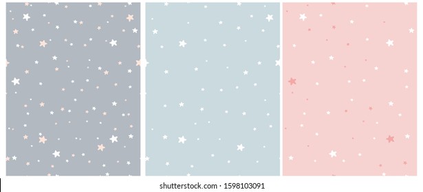 Tiny Stars Vector Patterns. Irregular Hand Drawn Simple Starry Sky Print for Fabric, Textile, Wrapping Paper. Infantile Style Galaxy Design. Little Stars Isolated on a Gray, Blue and Pastel Pink. 
