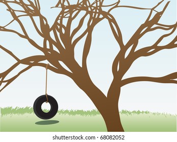 Tire swings hangs from leafless tree in grass field daytime
