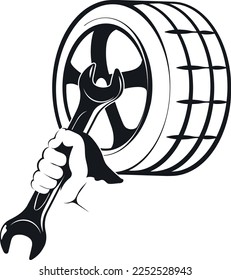 Tire wheel and wrench in the hand of a mechanic. Repair and service auto sign