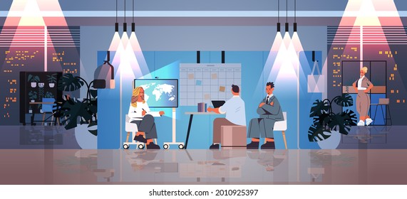 tired businesspeople working together in creative coworking center teamwork concept dark night office interior