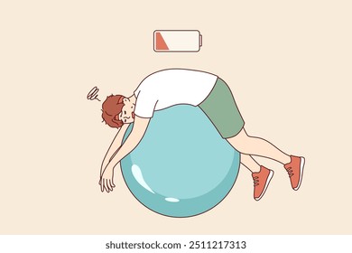Tired man lies on fitness ball with empty battery, symbolizing exhaustion and lack of vitality. Tired guy being lazy doing pilates to improve health or get rid of illnesses and excess weight