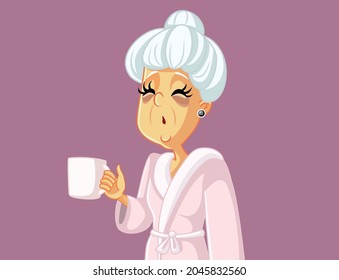 Tired Old Woman Holding a Coffee Mug Vector Cartoon. Exhausted elderly lady suffering from insomnia sleep deprivation
