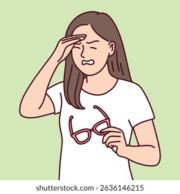 Tired woman holds her glasses and rubs eyes. Symbol of fatigue, eye strain, or tension caused by stress or screen exposure