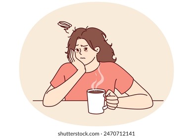 Tired woman with sad face drinks hot coffee and does not want to go to work due to lack of sleep. Upset girl is sitting at table with mug of coffee on Monday morning and is sad because weekend is over