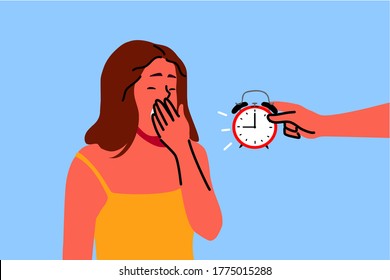 Tired young woman yawning with closed eyes exhausted after long hard day and invisible person holding alarm clock showing late time. Time sleep or wake up.