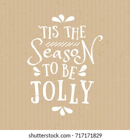 'Tis the Season to be Jolly - typographic design greeting card template with text in white on craft paper background.