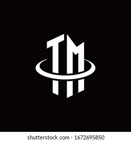 TM monogram logo in a hexagon style and surrounded by a ring