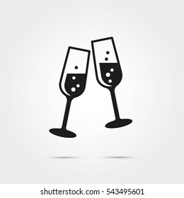 Toasting with two glasses of champagne on new years eve glyph icon