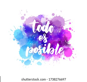 Todo es posible (Everything is possible in Spanish) - handwritten modern calligraphy lettering text on abstract watercolor paint splash background.  Purple and blue colored