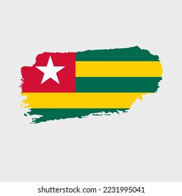 Togo flag with grunge texture. Vector illustration of flag painted with brush with grunge effect and watercolor stroke. Happy Independence Day.