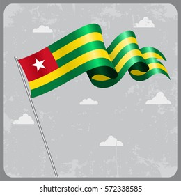 Togo flag wavy abstract background. Vector illustration.