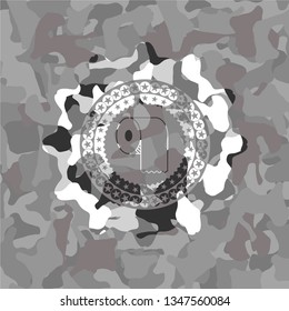 toilet paper icon inside grey camouflage emblem