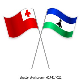 Tongan and Basotho crossed flags. Tonga combined with Lesotho isolated on white. Language learning, international business or travel concept.