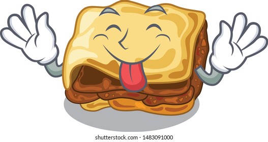 Tongue out moussaka above the character wooden table