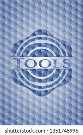 Tools blue emblem or badge with abstract geometric pattern background.