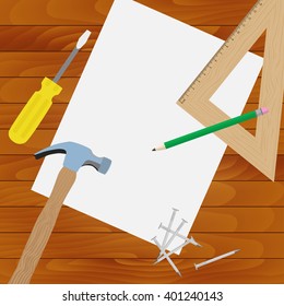 Tools lie on the wooden table. A hammer and a screwdriver.