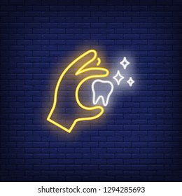 Tooth in hand neon sign. Luminous signboard with molar tooth. Night bright advertisement. Vector illustration in neon style for dentistry, clinic, healthcare