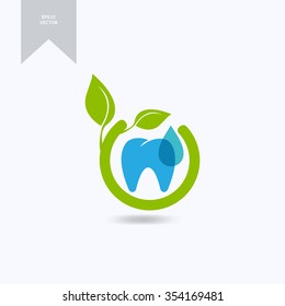 Tooth logo. Fresh dent with green leaves symbol.