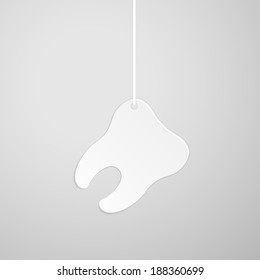 Tooth on a string on gray background