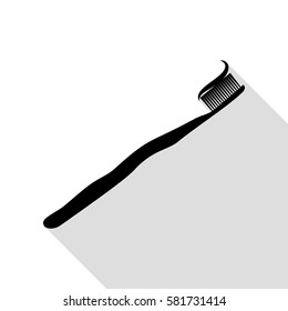 Toothbrush with applied toothpaste portion. Black icon with flat style shadow path.