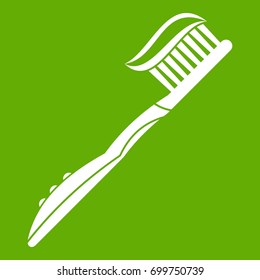 Toothbrush with toothpaste icon white isolated on green background. Vector illustration
