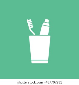Toothpaste and Tooth Brush In Cup Flat Icon On Green Background