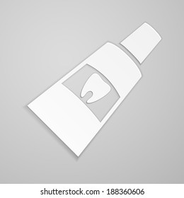 Toothpaste with tooth label on gray background