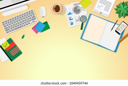 Top aerial View of business desk table with table PC,business paper work,a cup of coffee,empty notebook,flash drive,small tree,pen,mobile phone with business graphs,tablet.with copy space for text