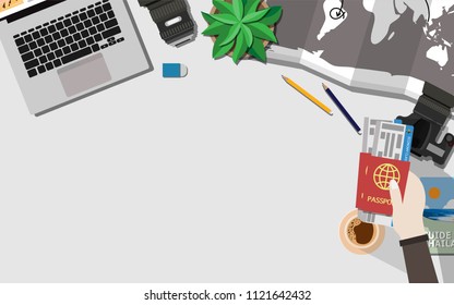 Top Down Flat Lay View Of Table With Laptop, Camera,lens,mobile Phone,a Cup Of Coffee,travel Book,hand Holding Passport And Plane Ticket,world Map,tree And Copy Space For Text